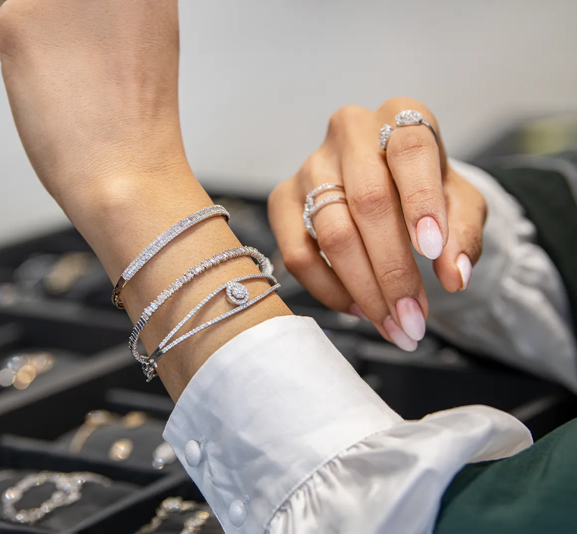 Diamond bracelets and rings worn at a jewelry counter